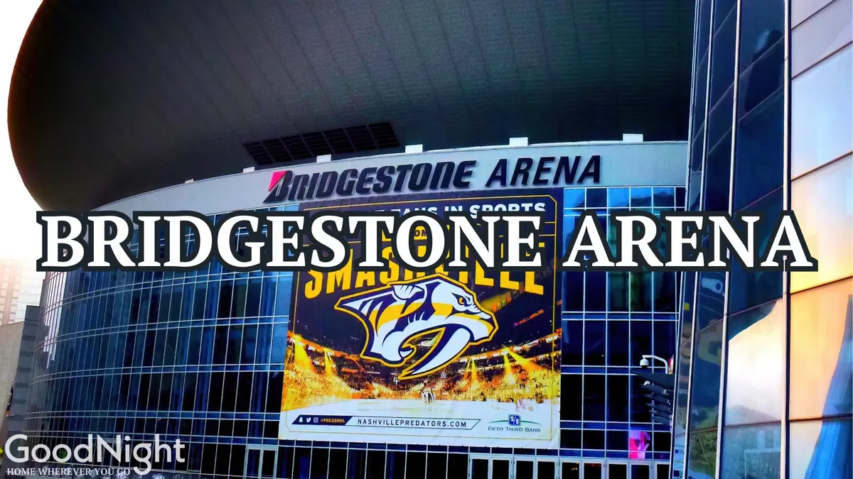 The exterior of Bridgestone Arena, adorned with the Nashville Predators banner and modern glass facade, is lively with activity and anticipation. The bright signage and active street scene create a sense of excitement and eventfulness.